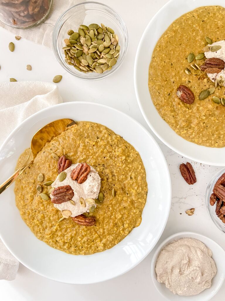 Two bowls of turmeric oatmeal on a white countertop.