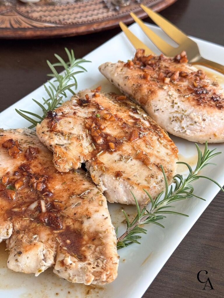 A plate of food with brown sauce and herbs.