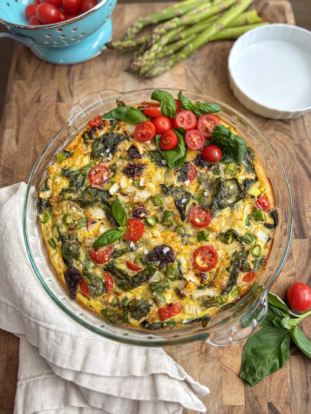 An asparagus frittata next to a linen napkin.