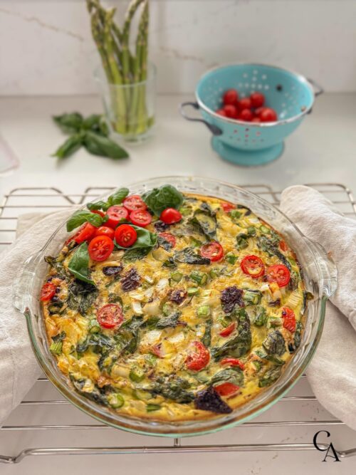 An asparagus frittata on a white countertop.