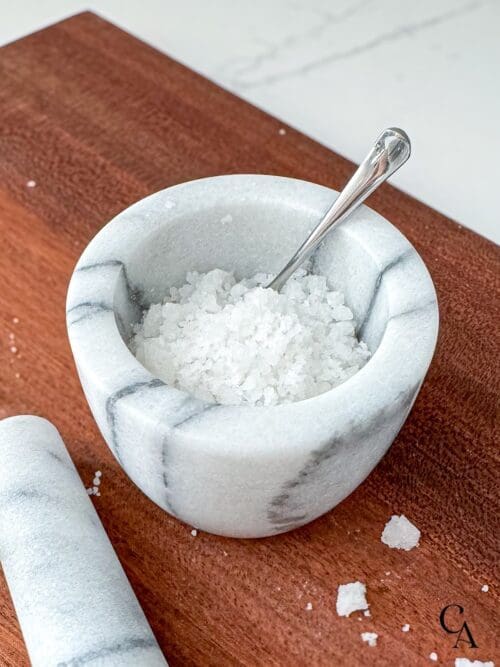 Flakey sea salt in a marble bowl.