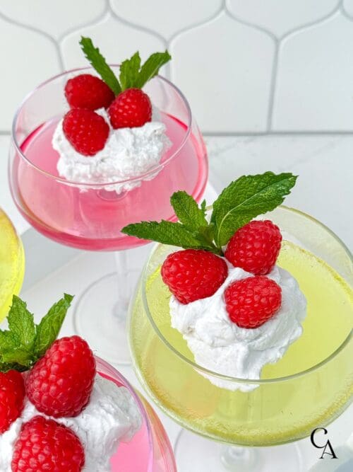 Dye-free lemon jello in a glass with raspberries and mint.