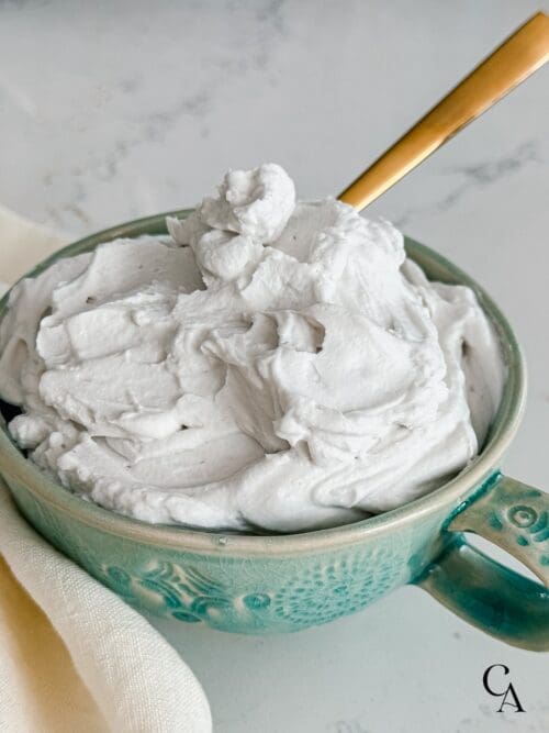 Whipped coconut cream in a turquoise bowl.