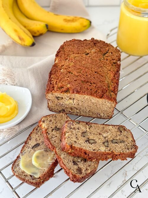 Banana bread with walnuts cooling on a wrack.
