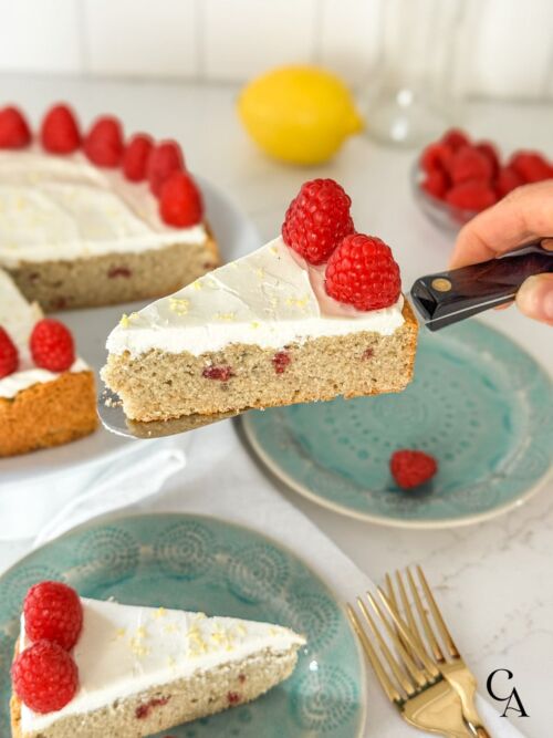 A slice of lemon raspberry cake on a serving knife.