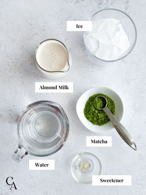Latte ingredients on a light grey counter.