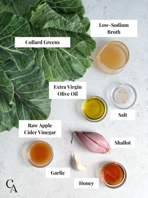 A bunch of collard greens next to small bowls of ingredients on a light gray countertop.