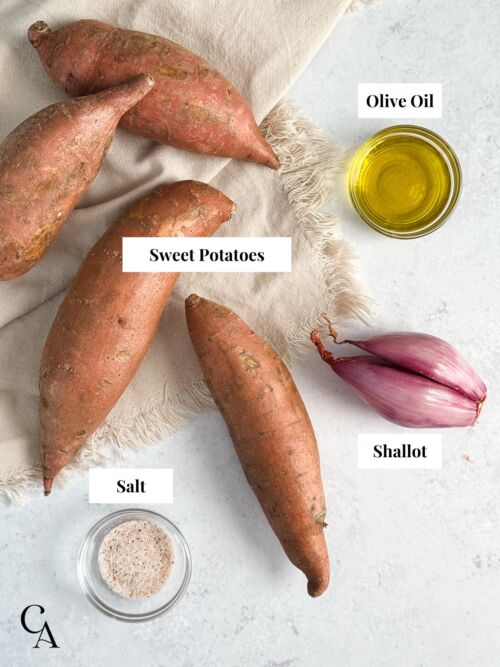 Sweet potatoes, a shallot and small bowls of olive oil and salt.