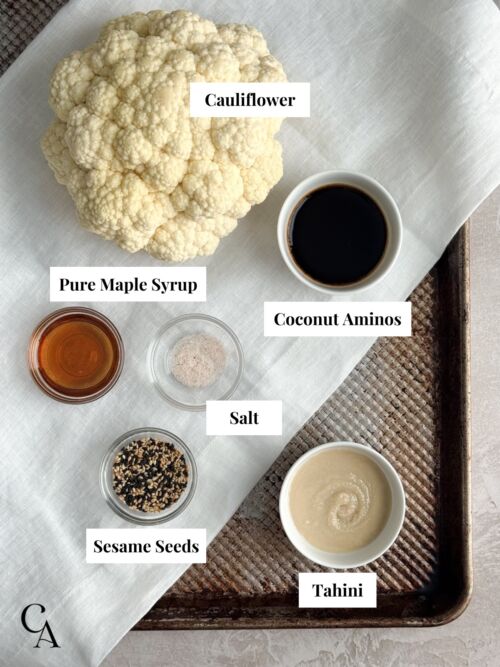 Ingredients for cauliflower steaks with maple tahini dressing, including cauliflower, tahini, coconut aminos, maple syrup, salt, and sesame seeds.