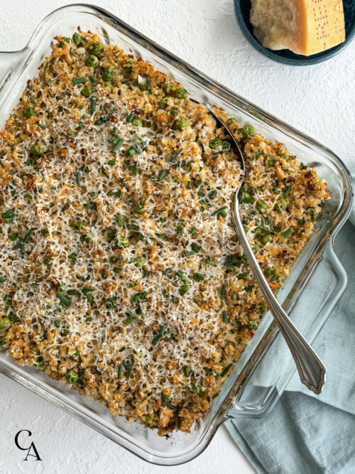 Parmigiano-Reggiano next to a salmon casserole with quinoa, cauliflower rice, peas and fresh herbs.