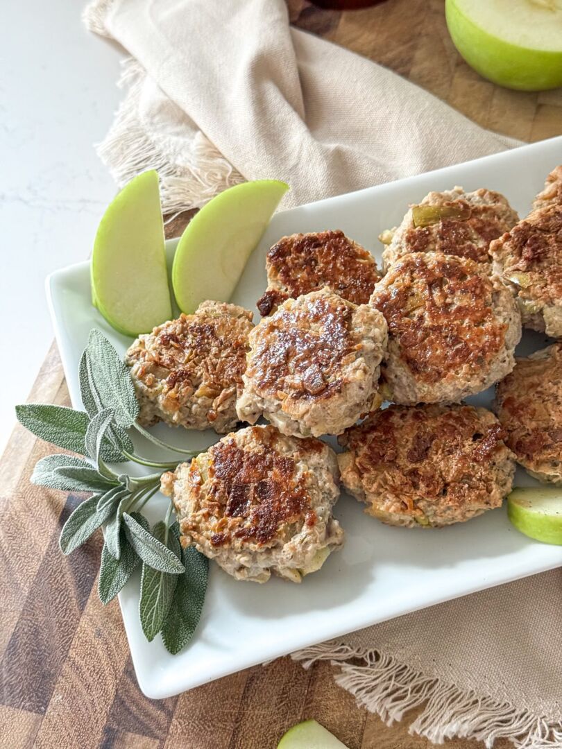 Breakfast fritters on a white serving platter, viewed from overhead.