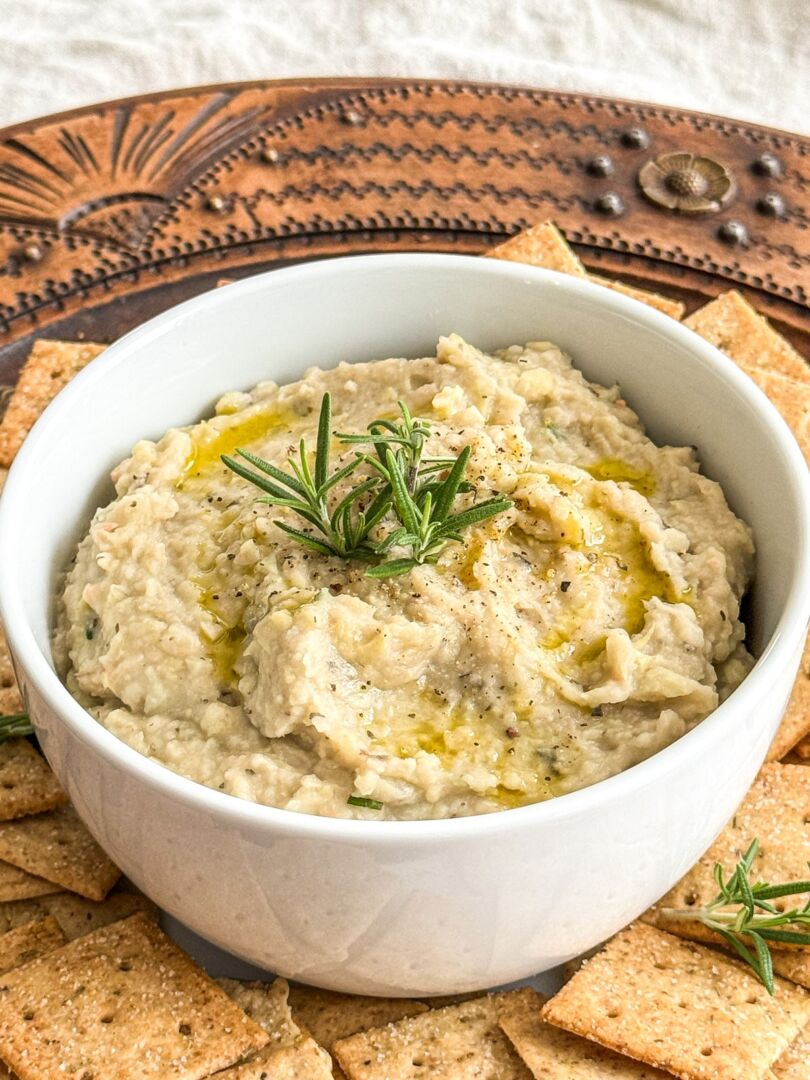 Gluten free snack dip in a small white bowl, viewed from overhead.